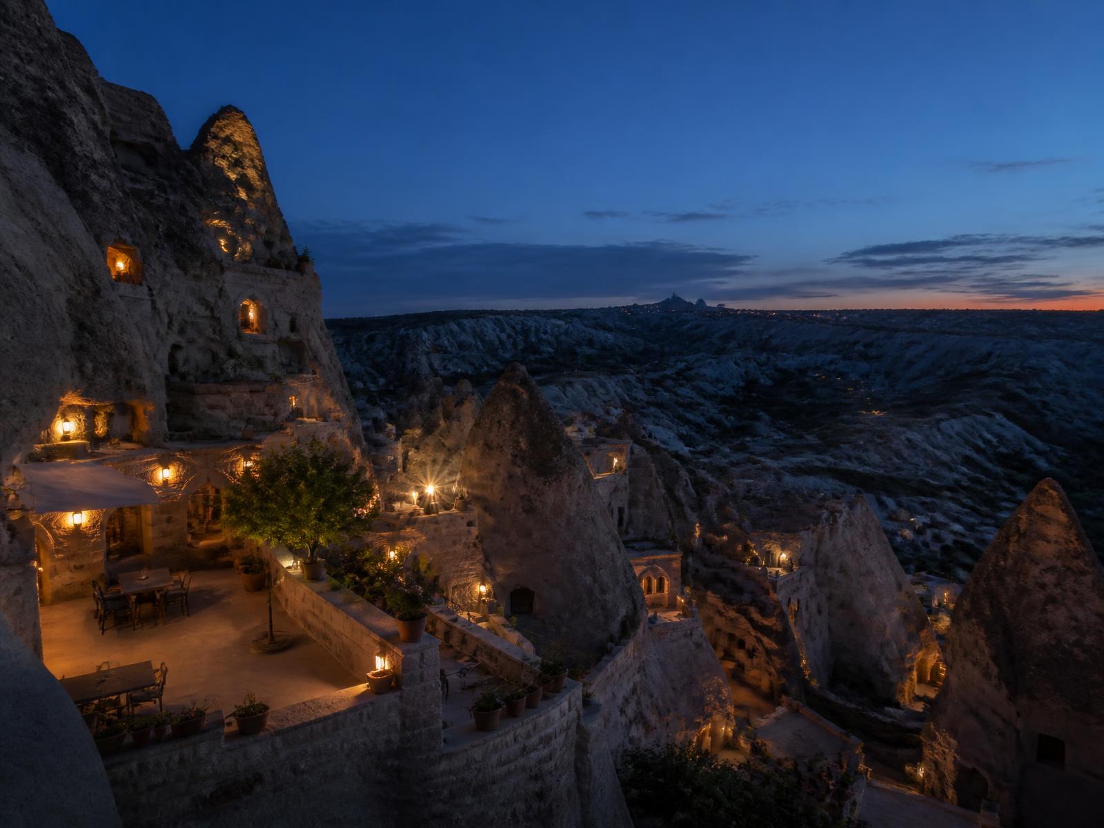 Cappadocian cave dwellings lit at dusk